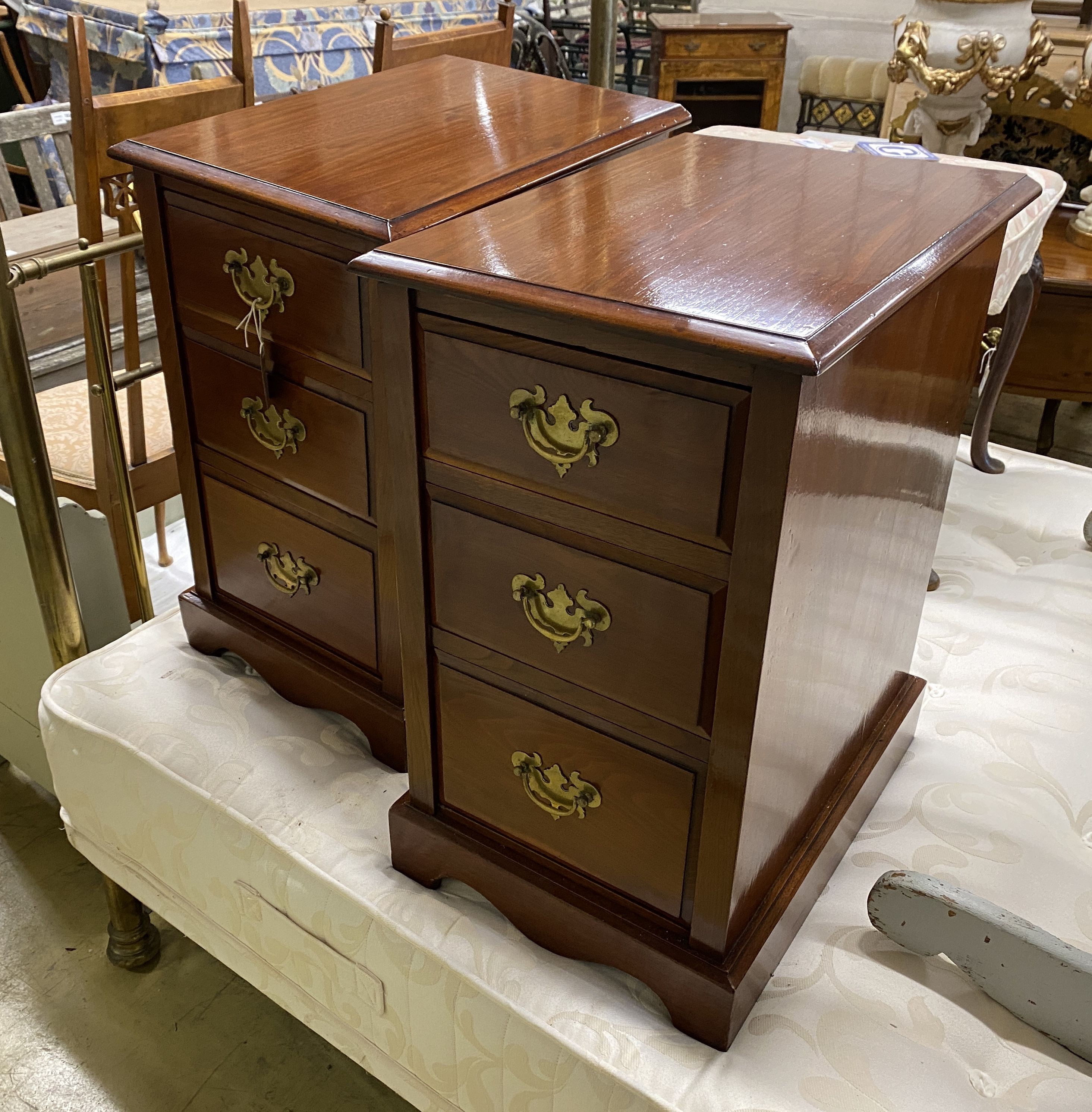 A pair of Edwardian walnut three drawer bedside chests, adapted, width 38cm, depth 54cm, height 65cm